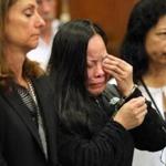 Xiao Ying Zhou (center) wept at her sentencing. Her lawyer, Michelle Troiano, is beside her.