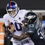 The Giants? Eli Manning is sacked by Nigel Bradham of the Eagles during Thursday night?s game. Manning has had little protection from a revamped offensive line this season. 