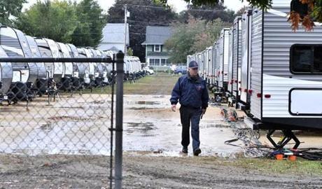 A Lawrence firefighter walked past a row of travel trailers Saturday.
