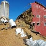 A grain silo fell onto the barn.
