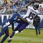 Baltimore Ravens wide receiver Michael Crabtree (15) catches a touchdown pass as he is defended by Tennessee Titans cornerback Malcolm Butler in the first half of an NFL football game Sunday, Oct. 14, 2018, in Nashville, Tenn. (AP Photo/Wade Payne)