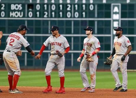 The scoreboard tells the story as Xander Bogaerts, Mookie Betts, Andrew Benintendi, and Jackie Bradley, Jr. celebrate the Red Sox? 8-6 victory.  
