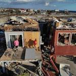 MEXICO BEACH, FL - OCTOBER 17: Bela (L) and Jaques Sebastiao begin the process of cleaning up their home after after it was heavily damaged by Hurricane Michael, on October 17, 2018 in Mexico Beach, Florida. Michael slammed into the Florida Panhandle on October 10 as a Category 4 storm causing widespread damage and claiming as many as 29 lives. (Photo by Joe Raedle/Getty Images) *** BESTPIX ***