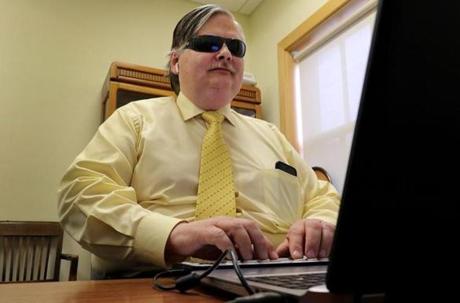 Brian Charlson, who was blinded at age 11, typed on a Braille keyboard in his office at the Carroll Center for the Blind in Newton. 
