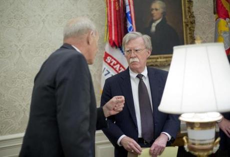 White House Chief of Staff John Kelly, left, talks with, White House National Security Advisor, John Bolton, center, in the Oval Office of the White House in Washington during President Donald Trump's meeting to discuss potential damage from Hurricane Michael, Wednesday, Oct. 10, 2018. (AP Photo/Pablo Martinez Monsivais)
