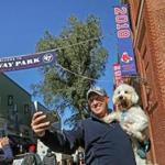 Joe Coen used his phone to snap a few celebratory selfies of himself and his dog Cooper in front of the newly installed championship banner.