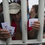 A Honduran migrant held tickets that let him and his family cross into Mexico on Saturday.