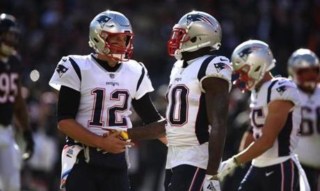 Chicago, IL - 10/21/2018 - (4th quarter) New England Patriots quarterback Tom Brady (12) congratulates New England Patriots wide receiver Josh Gordon (10) on his catch and run for extra yardage during the fourth quarter. New England Patriots vs. Chicago Bears at Soldier Field. - (Barry Chin/Globe Staff), Section: Sports, Reporter: Ben Volin, Topic: 21Patriots-Bears, LOID: 8.4.3538702313.

