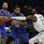 Boston, MA--10/22/2018-- Celtics Kyrie Irving (R) defends against Magic D.J. Augustin during the first quarter of game action at TD Garden in Boston. (Jessica Rinaldi/Globe Staff) Topic: Celtics-Magic Reporter: 