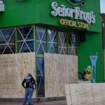 Workers boarded up a storefront in Mazatlan, Mexico, on Monday.