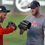 Boston, MA 10-22-18: Red Sox Game One starting pitcher Chris Sale (right) gets a hand from fellow pitcher Eduardo Rodriguez (left) after he got in some throwing in the outfield this afternoon. The Boston Red Sox and the Los Angeles Dodgers both held media availabilities and workouts at Fenway Park in anticipation of Tuesday night's Game One of the World Series. (Jim Davis/Globe Staff)