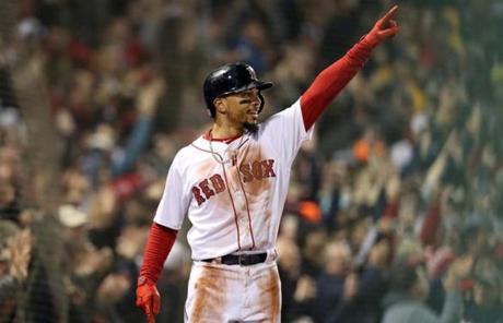 RED SOX SLIDER23 Boston, MA - 10/23/2018 - Mookie Betts waves to Andrew Benintendi after being driven home crossing the plate in the first inning. Manny Machado can't make the tag. The Boston Red Sox host the Los Angeles Dodgers in Game 1 of the World Series at Fenway Park. (Jim Davis/Globe Staff)
