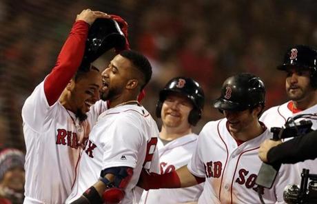 RED SOX SLIDER23 Boston, MA - 10/23/2018 - Mookie Betts (l) Celebrates with Eduardo Nunez after Nunez HR in 7th inning. The Boston Red Sox host the Los Angeles Dodgers in Game 1 of the World Series at Fenway Park. (Jim Davis/Globe staff)
