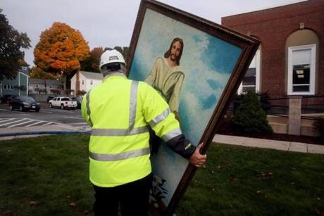 Building inspector Jack Roberto carried a painting of Jesus  from the First Baptist Church after fire gutted the church Tuesday night. The painting somehow was not damaged by the fire.
