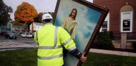 Building inspector Jack Roberto carried a painting of Jesus  from the First Baptist Church after fire gutted the church Tuesday night. The painting somehow was not damaged by the fire.
