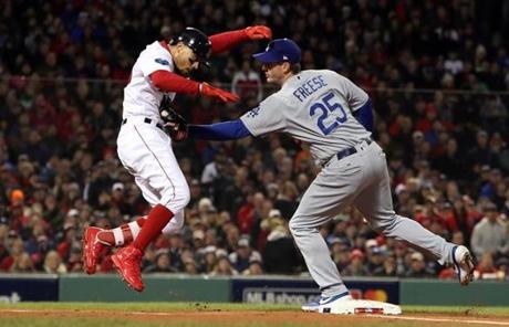 RED SOX SLIDER24 Boston, MA - 10/24/2018 - First baseman David Freese tags out Mookie Betts after a high throw during 1st inning of Game 2 of the World Series. The Boston Red Sox host the Los Angeles Dodgers in Game 2 of the World Series at Fenway Park. (Jim Davis/Globe staff)
