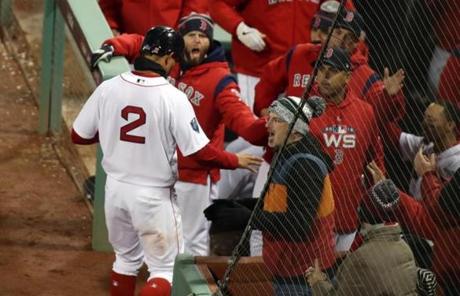 RED SOX SLIDER24 24redsoxSlider22 Boston, MA - 10/24/2018 -Xander Bogaerts greeted at the dugout by Dustin Pedroia and others after scoring during 2nd inning of Game 2 of the World Series. The Boston Red Sox host the Los Angeles Dodgers in Game 2 of the World Series at Fenway Park. (Stan Grossfeld/Globe staff)
