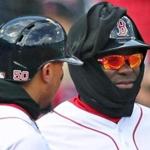 Red Sox third base coach Carlos Febles (right) bundled up for a game  at Fenway Park in early April. It?ll feel like an early spring night at Fenway Park for Games 1 and 2.
