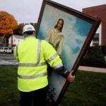 Building inspector Jack Roberto carried a painting of Jesus  from the First Baptist Church after fire gutted the church Tuesday night. The painting somehow was not damaged by the fire.