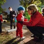 Martha Coakley, right, greeted trick or treater Caroline Thomson-Schwalb, 3, while handing out candy at her home in Medford on Halloween night. 