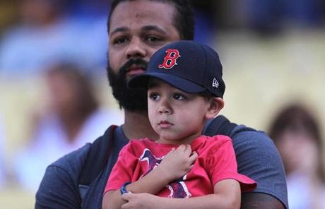 RED SOX SLIDER26 Los Angeles, CA - 10/26/2018 - Father and son watch players warm up on the field before Game 3 of the World Series. The Los Angeles Dodgers host the Boston Red Sox in Game 3 of the World Series at Dodger Stadium. (Jim Davis/Globe staff)
