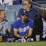 From right, Los Angeles Dodgers part owner Magic Johnson, country singer Brad Paisley and Dallas Cowboy coach Jason Garrett watch Game 3 of the World Series baseball game between the Boston Red Sox and Los Angeles Dodgers on Friday, Oct. 26, 2018, in Los Angeles. (AP Photo/David J. Phillip)