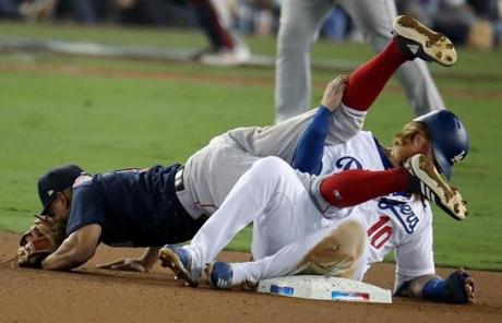 RED SOX SLIDER26 Los Angeles, CA - 10/26/2018 - Dodgers Justin Turner collides with Red Sox Xander Bogaerts at second base in the eighth inning. Los Angeles Dodgers hosted the Boston Red Sox in Game 3 of the World Series at Dodger Stadium. (Stan Grossfeld/Globe Staff)

