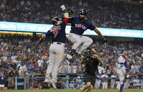 RED SOX SLIDER26 Los Angeles, CA - 10/26/2018 - Jackie Bradley Jr. Jumps with Christian Vazquez after Bradley's home run in the eighth inning tying the game in Game 3 of the World Series. The Los Angeles Dodgers host the Boston Red Sox in Game 3 of the World Series at Dodger Stadium. (Jim Davis/Globe staff)
