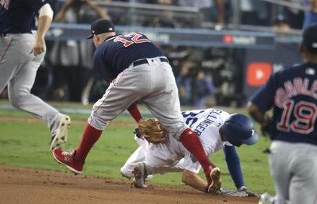 RED SOX SLIDER26 Los Angeles, CA - 10/26/2018 - Red Sox Brock Holt tags out Dodgers Cody Bellinger after he was picked off by David Priec (not pictured) in the ninth inning. Los Angeles Dodgers hosted the Boston Red Sox in Game 3 of the World Series at Dodger Stadium. (Stan Grossfeld/Globe Staff)
