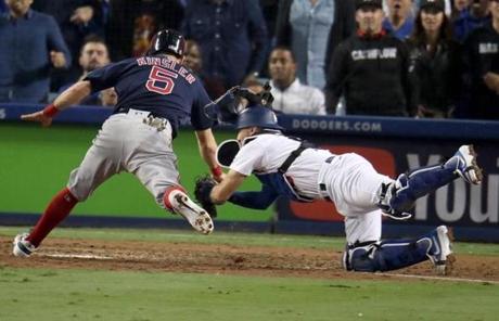 RED SOX SLIDER26 Los Angeles, CA - 10/26/2018 - Dodgers Austin Barnes tags out Red Sox Ian Kindler at home plate in the tenth inning. Los Angeles Dodgers hosted the Boston Red Sox in Game 3 of the World Series at Dodger Stadium. (Stan Grossfeld/Globe Staff)
