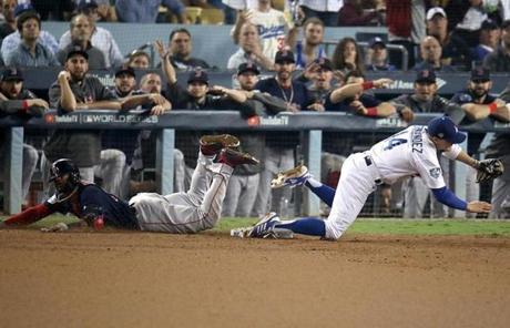 RED SOX SLIDER26 Los Angeles, CA - 10/26/2018 - Red Sox Eduardo Nunez is safe at first base against Dogders Kike Herndanez in the 13th inning. Los Angeles Dodgers hosted the Boston Red Sox in Game 3 of the World Series at Dodger Stadium. (Stan Grossfeld/Globe Staff)
