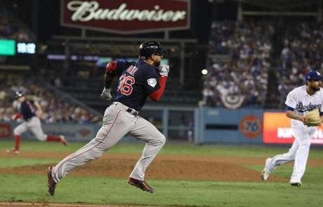 RED SOX SLIDER26 Los Angeles, CA - 10/26/2018 -Eduardo Nunez runs towards first as Brock Holt heads to third and eventually scores on the play in the thirteenth inning in Game 3 of the World Series. The Los Angeles Dodgers host the Boston Red Sox in Game 3 of the World Series at Dodger Stadium. (Jim Davis/Globe staff)
