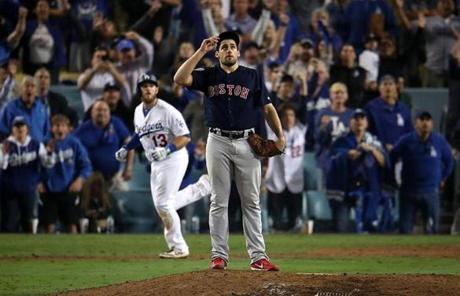 RED SOX SLIDER26 Los Angeles, CA - 10/27/2018 - Red Sox Nathan Eovaldi watches the flight of Dodgers Max Muncy (background) walk off home run in the 18th inning. Los Angeles Dodgers hosted the Boston Red Sox in Game 3 of the World Series at Dodger Stadium. (Stan Grossfeld/Globe Staff)
