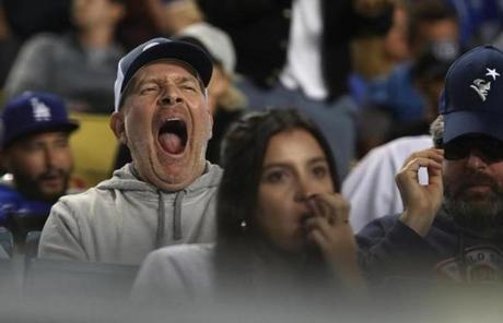 RED SOX SLIDER26 Los Angeles, CA - 10/26/2018 - A tired fan in the seventeenth inning in Game 3 of the World Series. The Los Angeles Dodgers host the Boston Red Sox in Game 3 of the World Series at Dodger Stadium. (Jim Davis/Globe staff)
