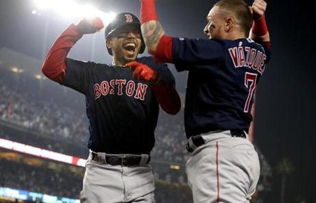 RED SOX SLIDER28 Los Angeles, CA - 10/28/2018 - Mookie Betts celebrates with Christian Vazquez after hitting a home run in the sixth inning.The Los Angeles Dodgers host the Boston Red Sox in Game 5 of the World Series at Dodger Stadium. (Jim Davis/Globe staff)
