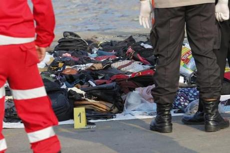 Emergency workers inspected debris recovered from waters near where a passenger crashed in Jakarta, Indonesia Monday.  
