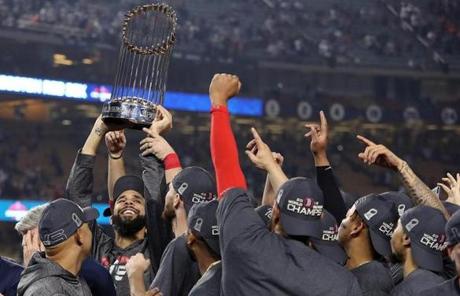 RED SOX SLIDER28 Los Angeles, CA: 10-28-18: David Price hoists the trophy as the Red Sox celebrate their World Series victory. The Boston Red Sox visited the Los Angeles Dodgers in Game Five of the World Series at Dodger Stadium. (Jim Davis/Globe Staff)
