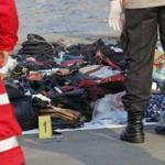 Emergency workers inspected debris recovered from waters near where a passenger crashed in Jakarta, Indonesia Monday.  