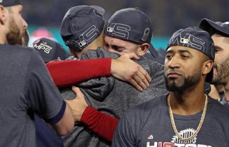 Los Angeles, CA: 10-28-18: As he hugged teammate David Price (back to camera) Rick Porcello appeared to be in tears. Also pictured are Chris Sale (far left) Eduardo Nunez and J.D. Martinez. The Boston Red Sox visited the Los Angeles Dodgers in Game Five of the World Series at Dodger Stadium. (Jim Davis/Globe Staff) 
