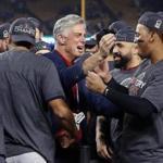 Los Angeles, CA: 10-28-18: Red Sox president of baseball operations Dave Dombrowski (left) celebrates with team players Sandy Leon and Rafael Devers following the victory. The Boston Red Sox visited the Los Angeles Dodgers in Game Five of the World Series at Dodger Stadium. (Jim Davis/Globe Staff)
