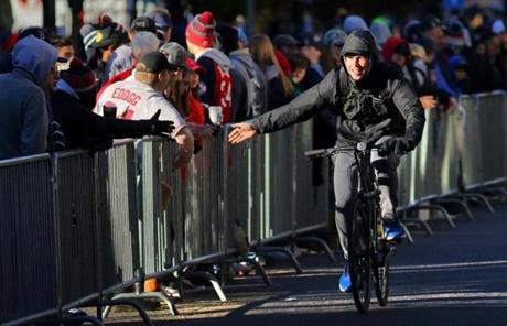 PARADE SLIDER Boston, MA - 10/31/18 - A cyclist slapped hands with fans on Boylston Street along the victory parade route for the 2018 World Series champion Boston Red Sox. (Lane Turner/Globe Staff) Reporter: () Topic: (paradephotos)
