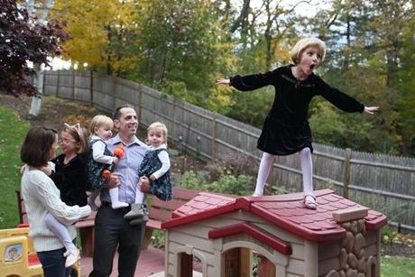Needham, Ma., 10/30/2018, This is the d'Hemecourt family, whose 5-year-old Michaela, on roof of playhouse, recently came out as transgender. The family hosted a block party to break the news and to ask their neighbors to support them in the campaign for Question 3, the ballot question that deals with transgender rights. Left to right: Liza, Elizabeth, 6, twins Winnie and Violet, 20 months, and Dad is Michael. Suzanne Kreiter/Globe staff 
