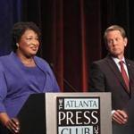 Democratic gubernatorial candidate for Georgia Stacey Abrams, left, speaks as her Republican opponent Secretary of State Brian Kemp looks on during a debate Tuesday, Oct. 23, 2018, in Atlanta. (AP Photo/John Bazemore, Pool)