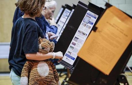 MIDTERMS SLIDER Family members accompany voters as they cast their ballots at the Whetstone Community Center polling location, Tuesday, Nov. 6, 2018, in Columbus, Ohio. Across the country, voters headed to the polls Tuesday in one of the most high-profile midterm elections in years. (AP Photo/John Minchillo)
