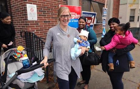 Boston, MA - 11/6/18 - As Ashley Draviam (cq), center, emerges from the Ward 15, Precinct 4 polling place, with her 2-month-old daughter Leena Draviam (cq), in-going 23-month-old Jaluna DuJour (cq), right, shouts ?Baby!? Enjoying the moment are her mom Joanne DuJour (cq) and Marenda Brown (cq), right. Photo by Pat Greenhouse/Globe Staff Topic: 07earlyvotingMetro Reporter: XXX
