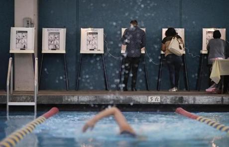 MIDTERMS SLIDER Sarah Salem, 34, foreground, swims as voters cast their ballots at Echo Deep Pool Tuesday, Nov. 6, 2018, in Los Angeles. (AP Photo/Jae C. Hong)
