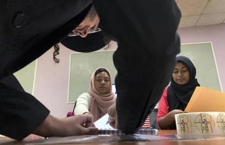 MIDTERMS SLIDER Romana Akter, left, and Urrmi Begum hand out ballot papers to an orthodox jewish man registering to cast his vote on Tuesday, Nov. 6, 2018, in Brooklyn borough of New York. (AP Photo/Wong Maye-E)
