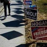 (FILES) In this file photo taken on October 25, 2018 a man walks away past campaign signs after voting during early voting at a community center in Potomac, Maryland, two weeks ahead of the key US midterm polls. - Millions of Americans will be barred from casting ballots in the November 6, 2018 crucial midterm elections due to electoral rules at the state level, which effectively exclude many minority voters to the detriment of Democrats.Nearly six million Americans are excluded from voting because they are imprisoned, on parole or awaiting sentencing. African-Americans, who are overrepresented in the US penal system, are four times more likely to be unable to vote than the rest of the population, according to The Sentencing Project, a nonprofit organization. (Photo by Brendan Smialowski / AFP)BRENDAN SMIALOWSKI/AFP/Getty Images