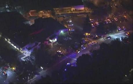In this image made from aerial video, police vehicles blocked an intersection near the reported shooting in Thousand Oaks, Calif. 
