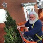Boston 11/7/18 Bill Schaaf, 59 from Jamaica Plain manuevers a lift to the Christmas tree being worked on at the facade of the Macy store in Downtown Crossing. During the holiday season, he works as Santa.Photo by John Tlumacki/Globe Staff(sports)